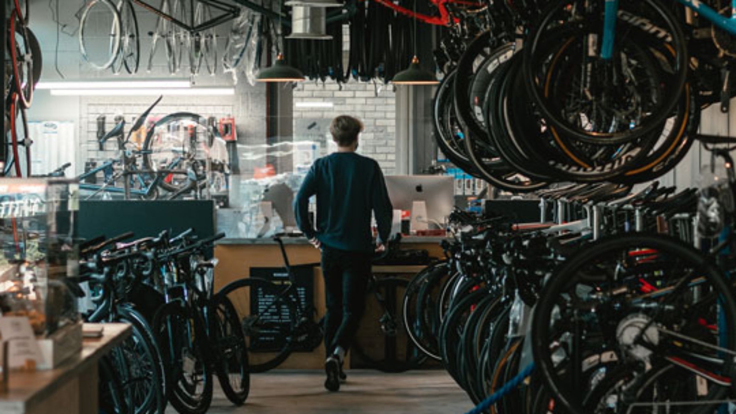 man walking through bike shop