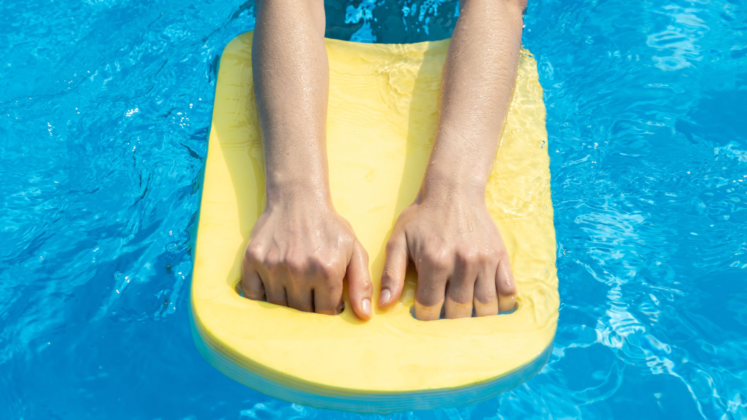 A woman does Swim Workout with Tools