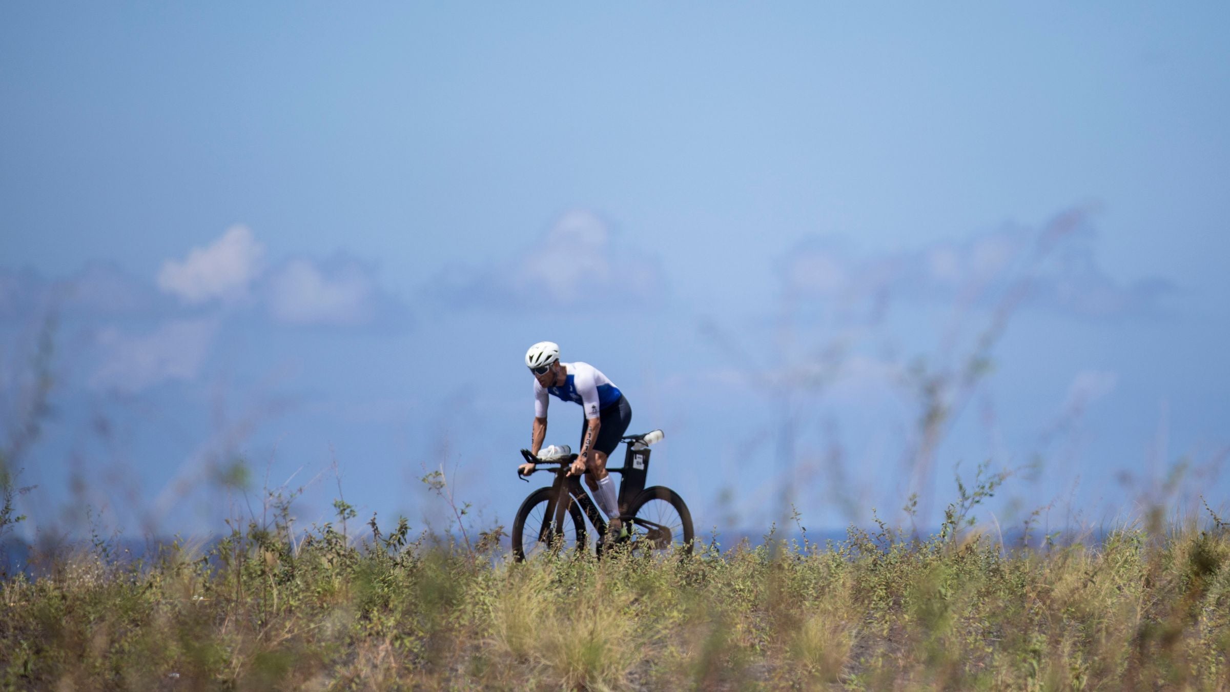 A triathlete races after a Triathlon Base Training Plan