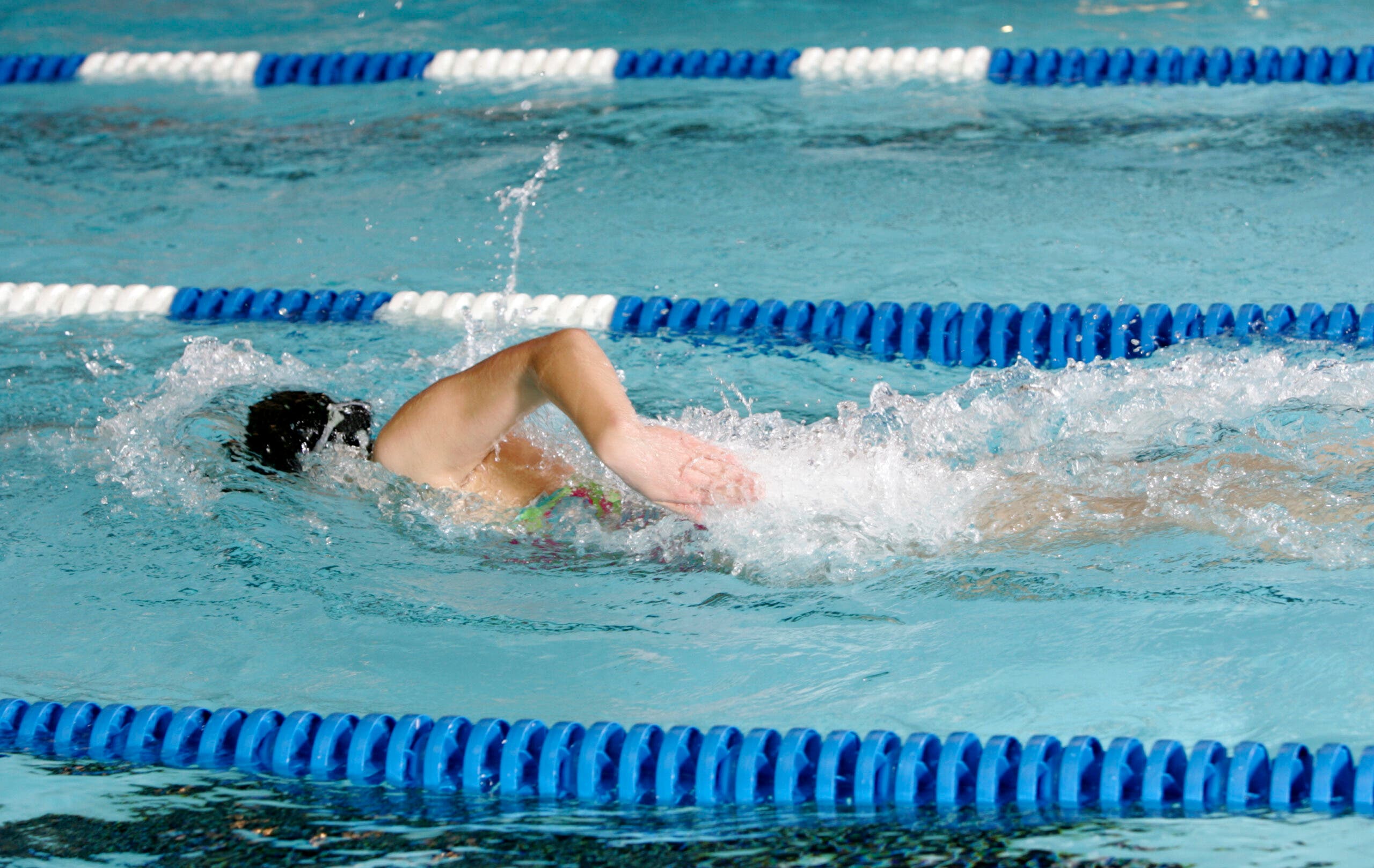 a swimmer does a workout from a triathlon base training plan