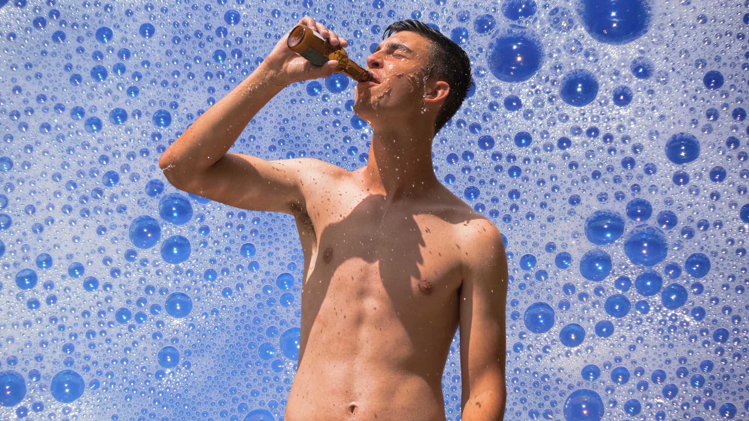 A man drinks one of the Best Shower Beers in the shower