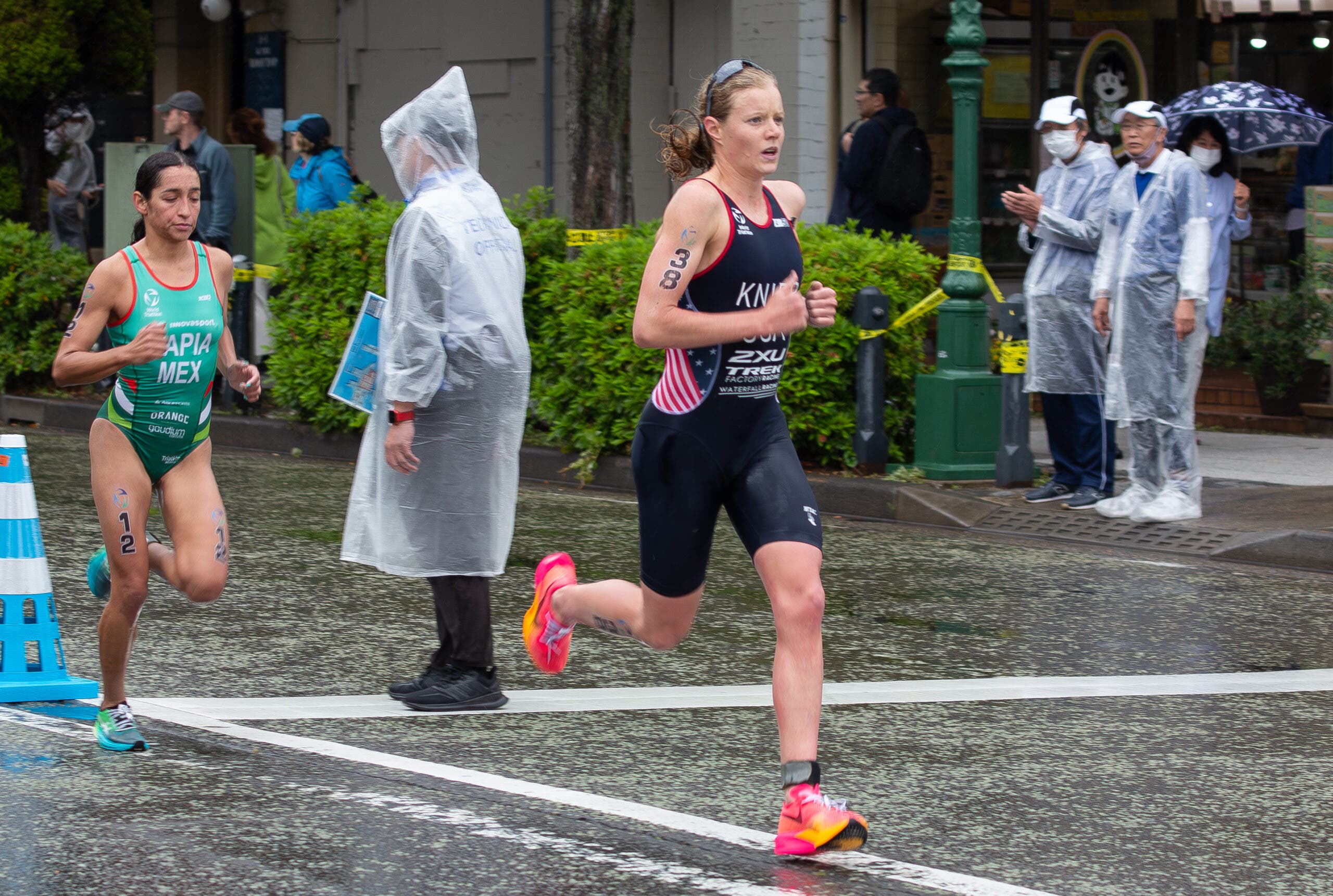 Taylor Knibb in a Team USA triathlon singlet, runs in a race.