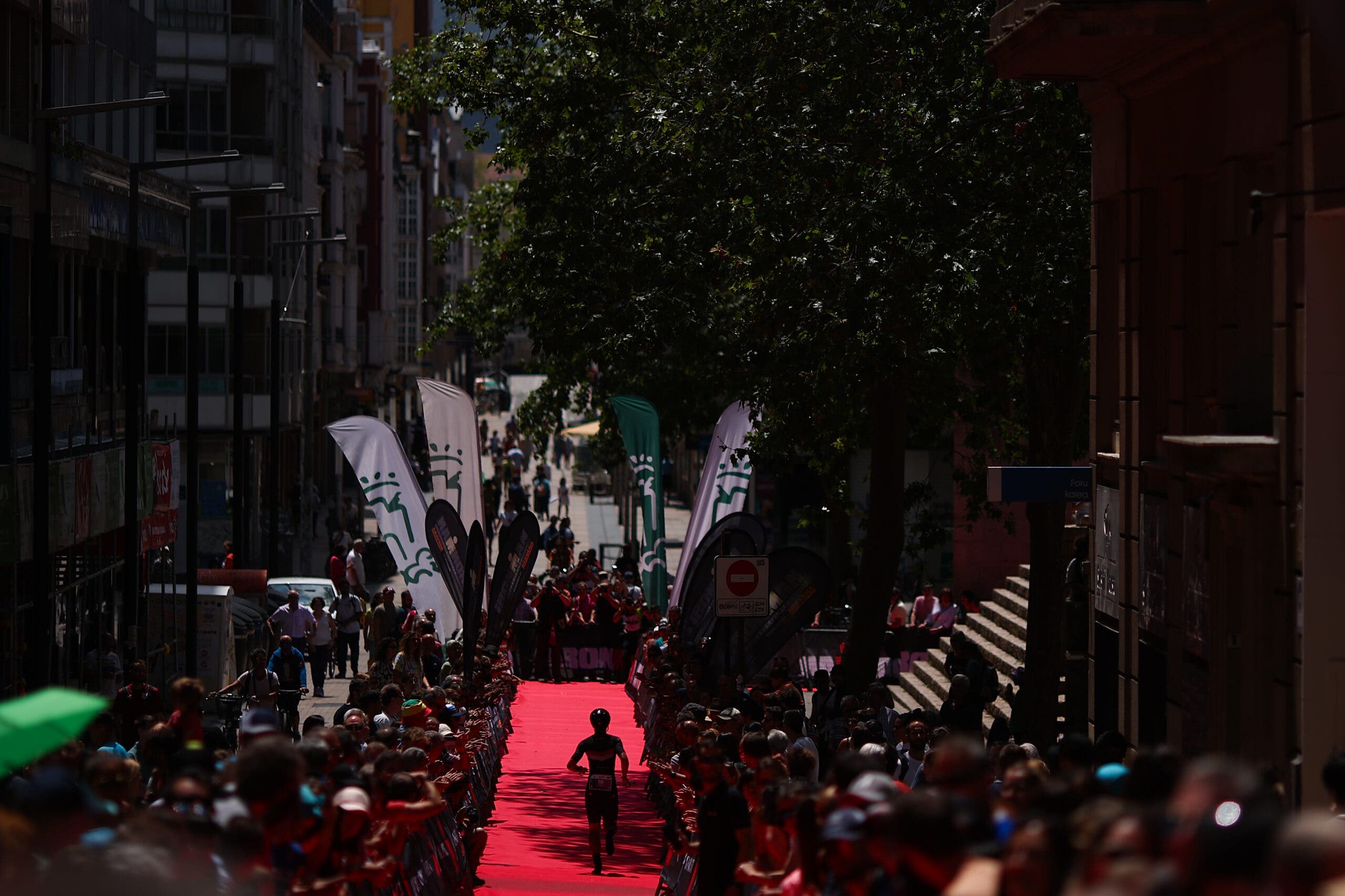 Triathletes make their way to the finish line, after which they may be drug tested.