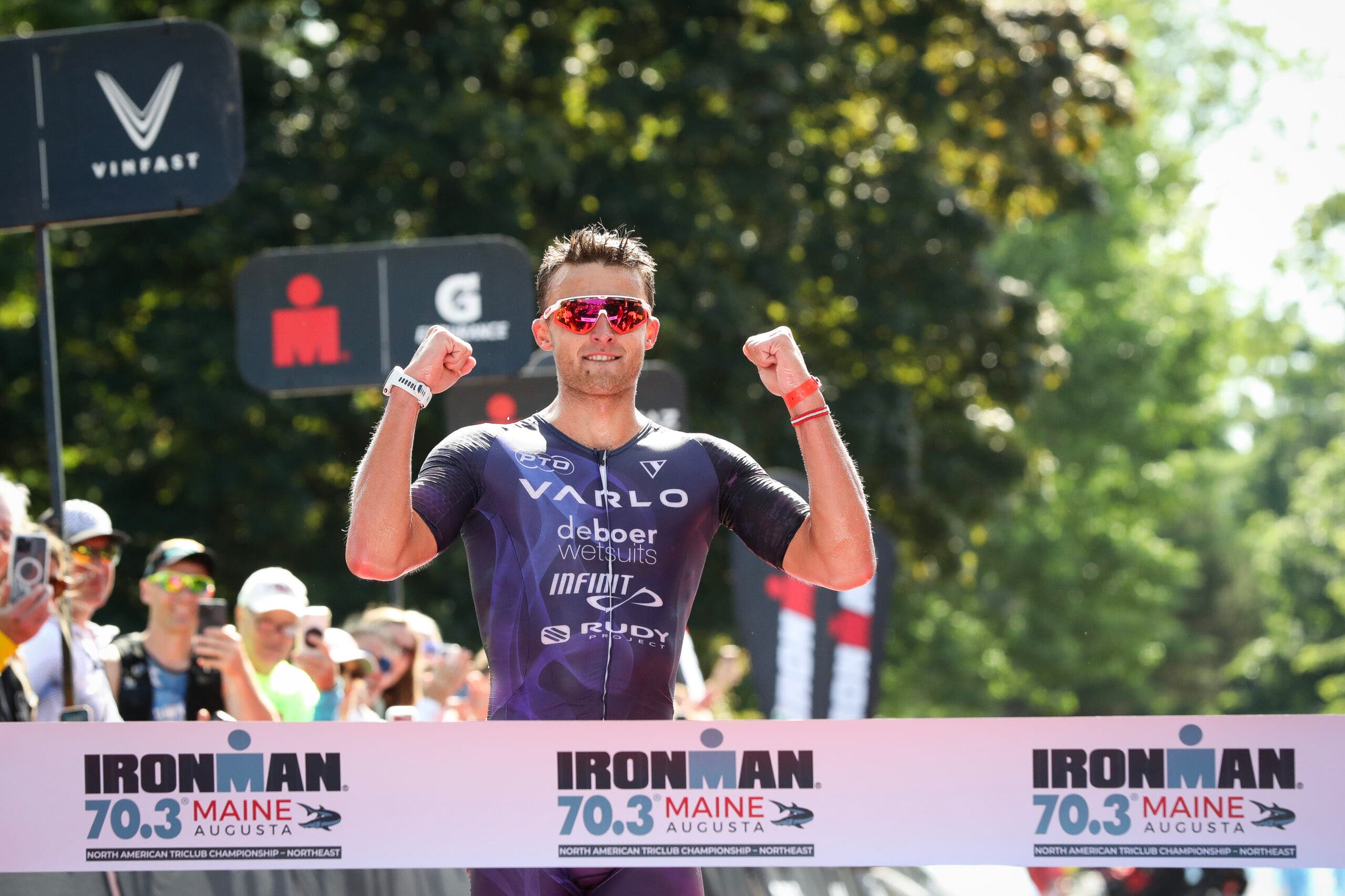Trevor Foley crosses the finish line to win the men's professional race at Ironman 70.3 Maine.