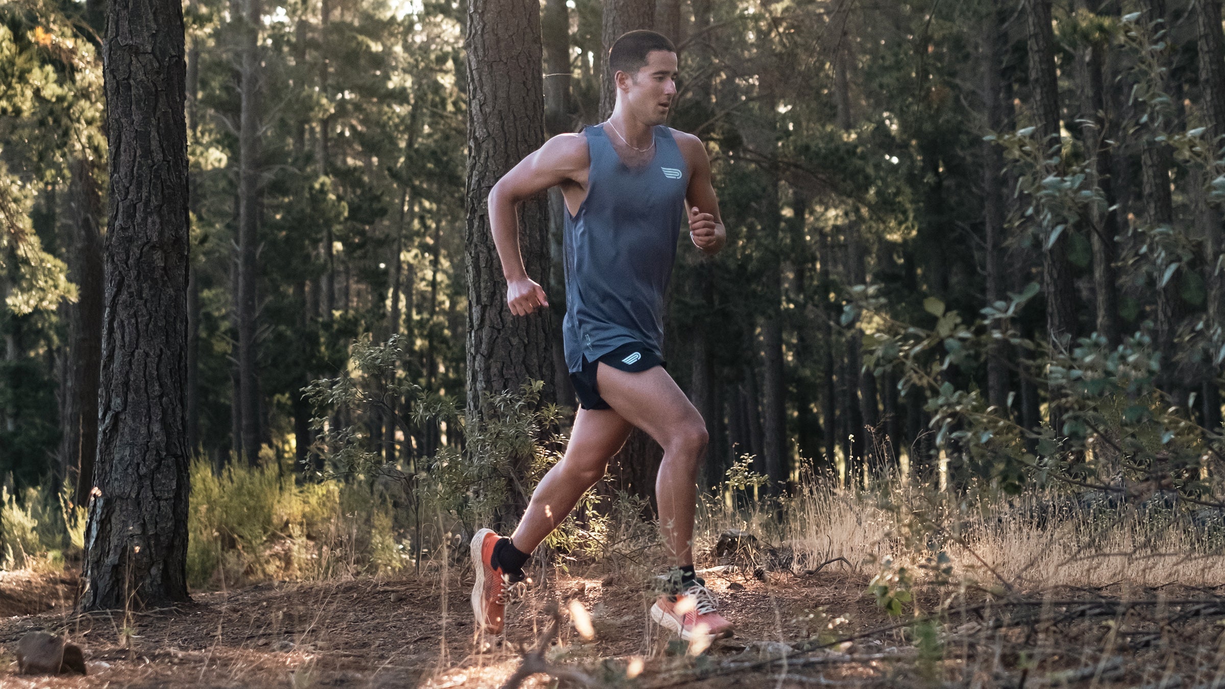 runner in woods wearing recycled-material shorts and top