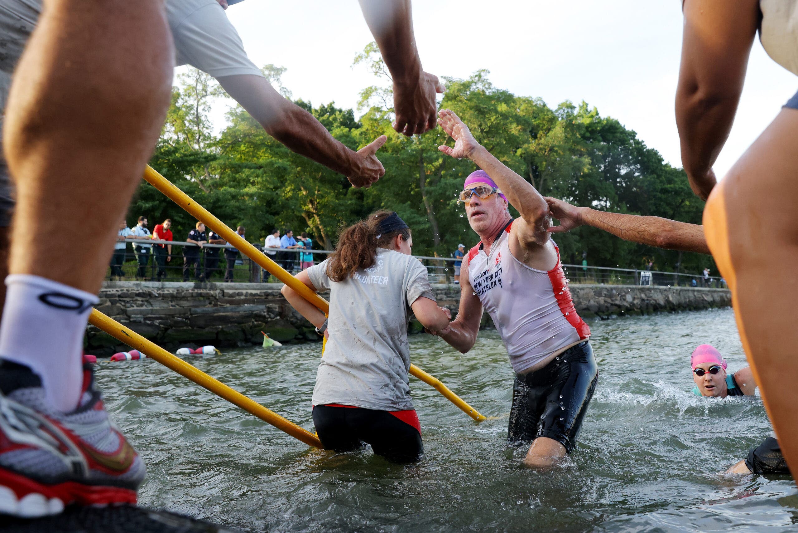 An athlete exits the New York City Triathlon swim course.