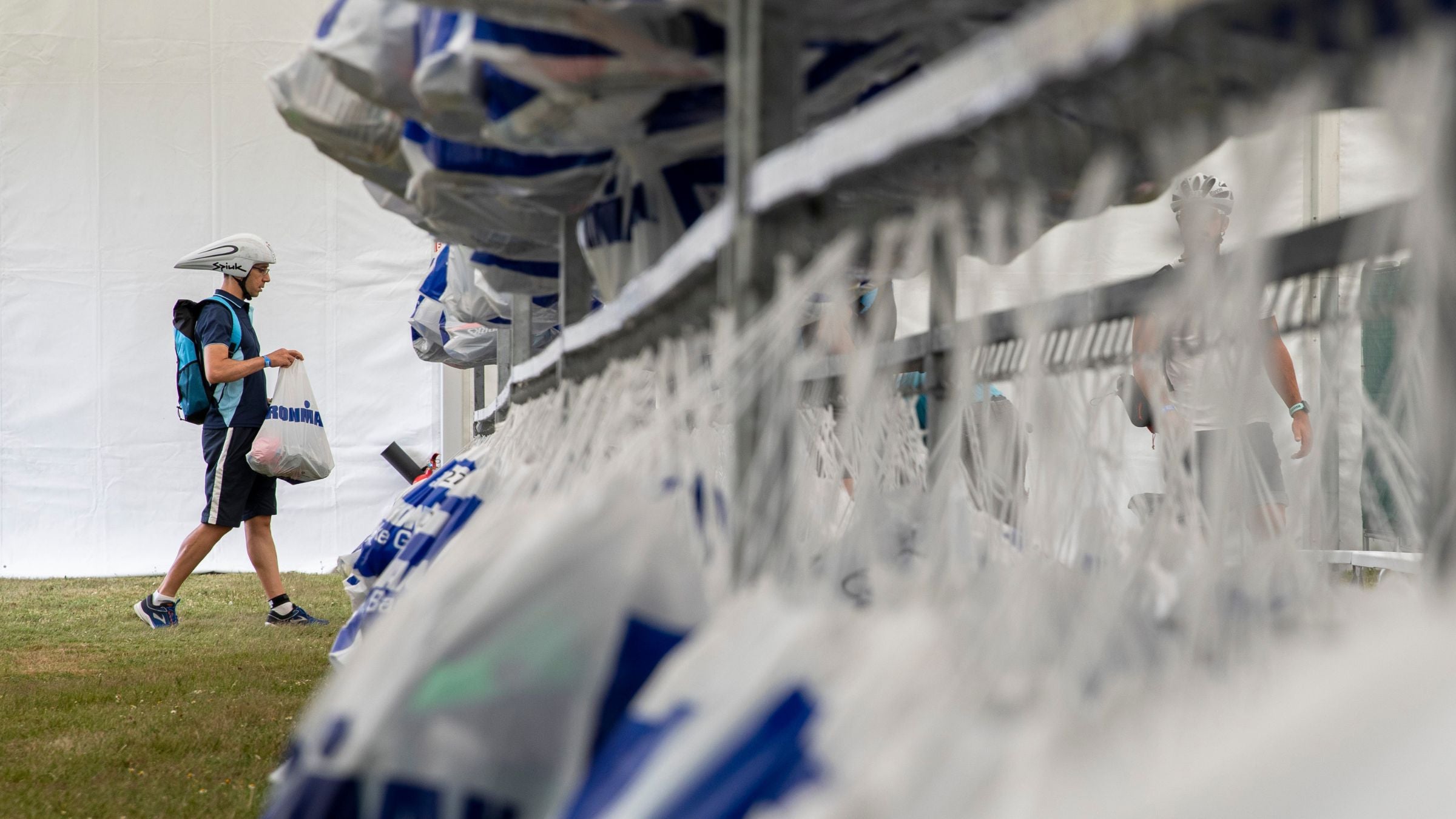 A triathlete drops off his gear bags the day before racing Ironman.