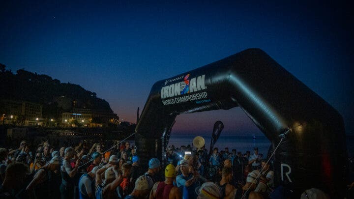 The swim start of the Ironman World Championship at sunrise, moments before the pro men start