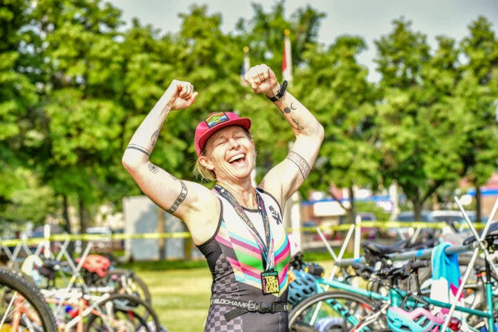 An athlete flexes at the Montana Women’s Triathlon, one of the best beginner triathlon races in the U.S. thanks to its empowerment of female athletes.