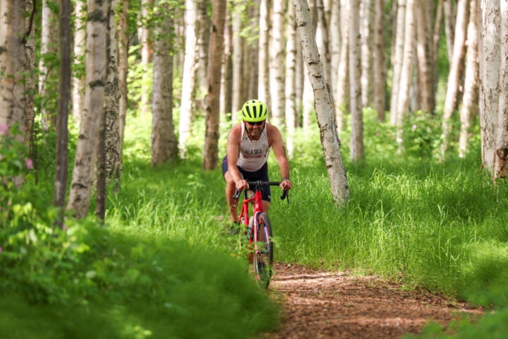 An athlete competes on the bike portion of the North Pole Triathlon, one of the best 2025 off-the-beaten-path multisport events in the U.S.