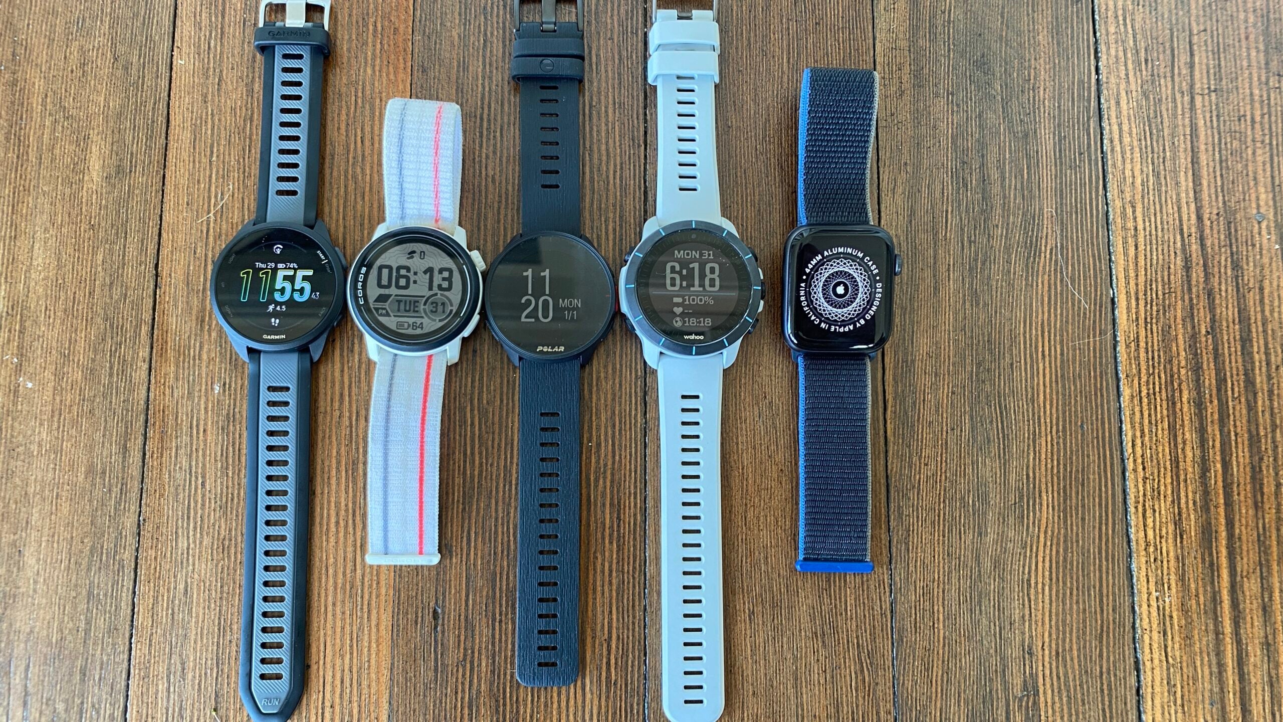 Here we see a side-by-side look at the Garmin Forerunner 165 next to the Coros Pace 3, Polar Pacer, Wahoo Rival, and Apple Watch SE.