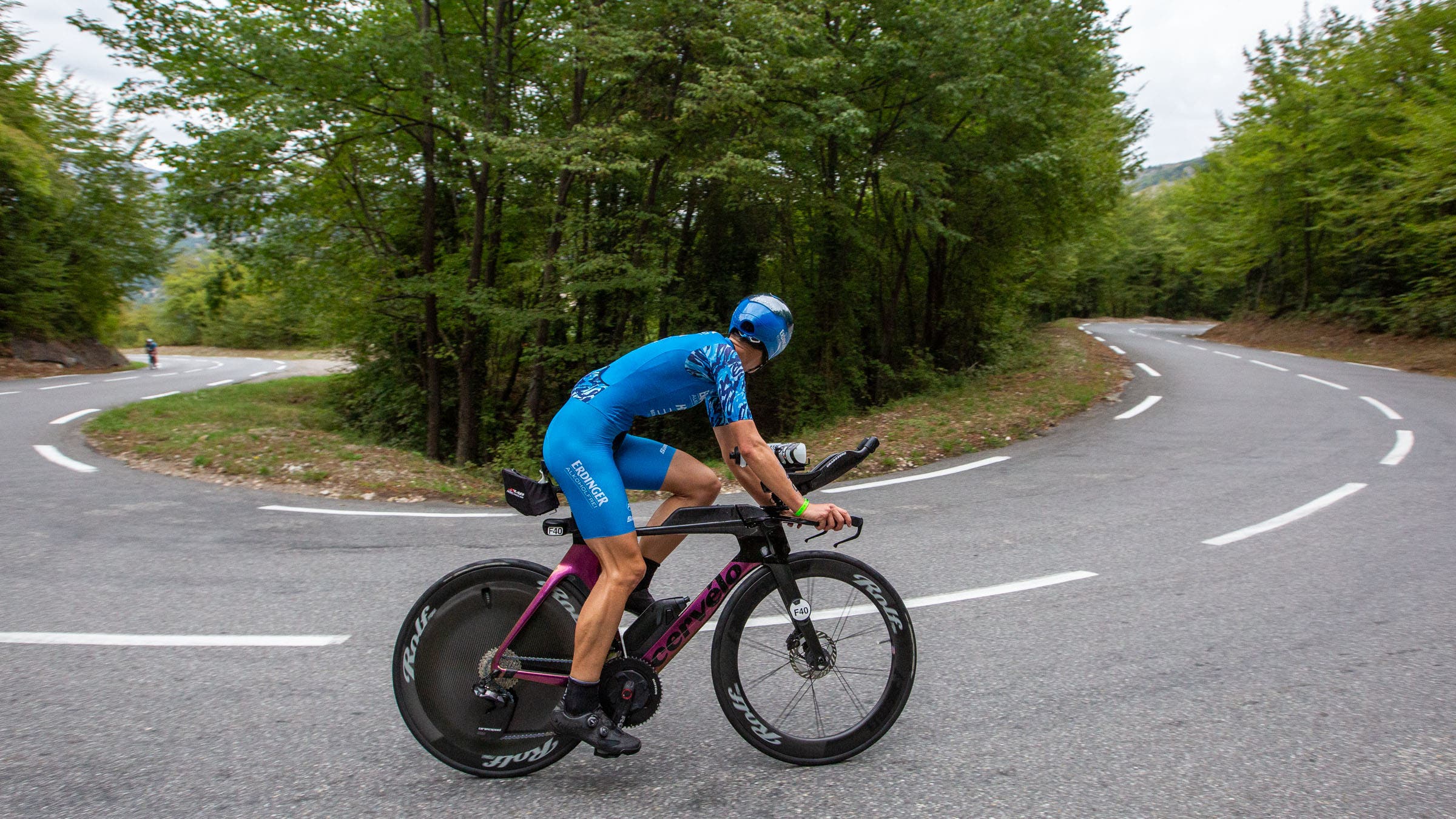 pro triathlete riding bike around a curve