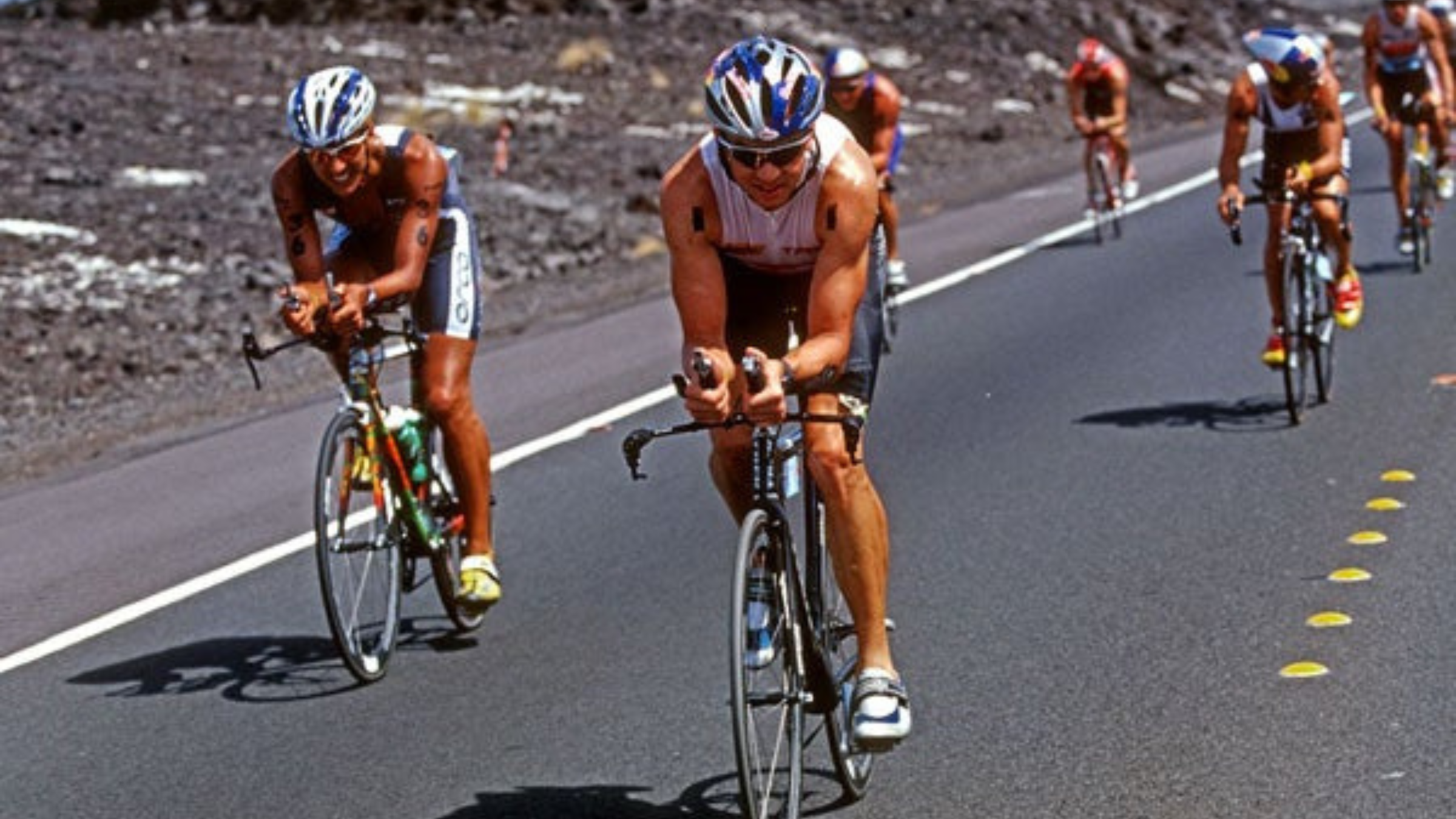 Two men ride side by side at 2003 Ironman World Championship