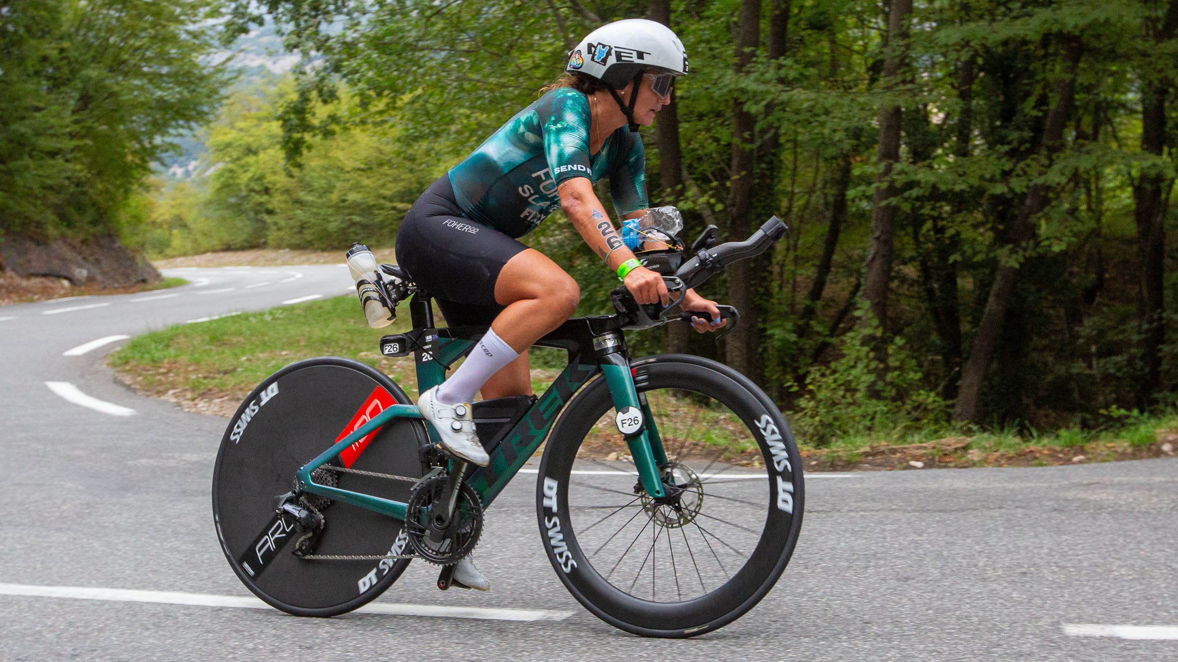 woman riding tri bike on road