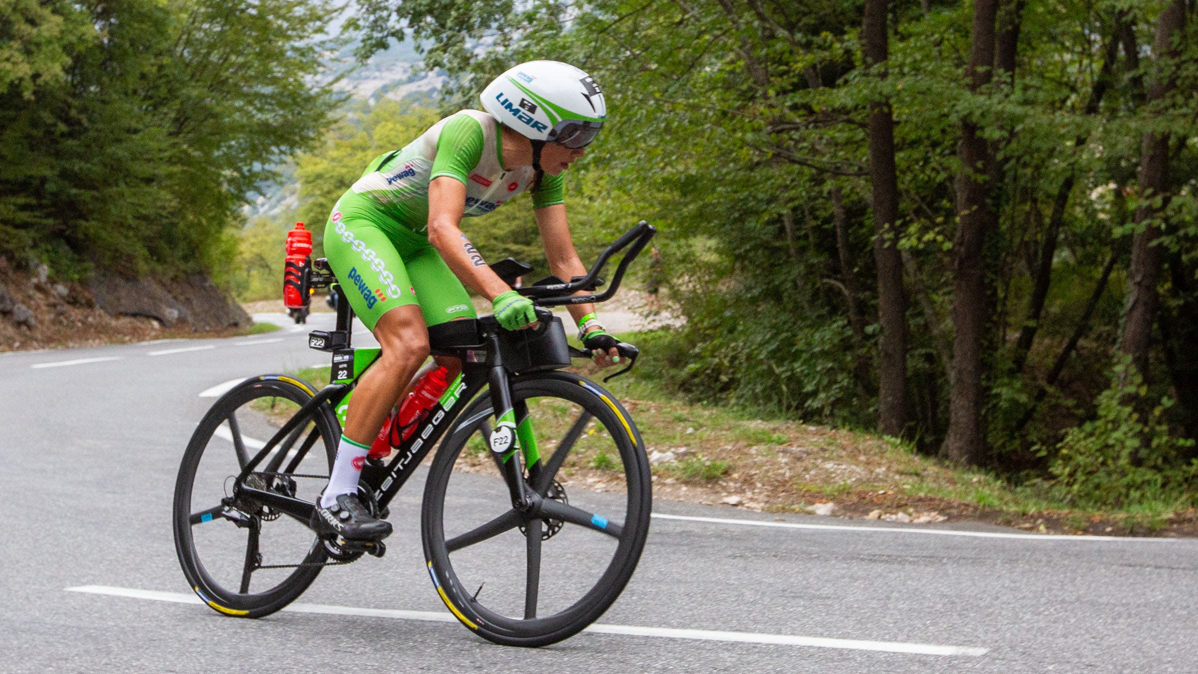 woman riding triathlon bike on road
