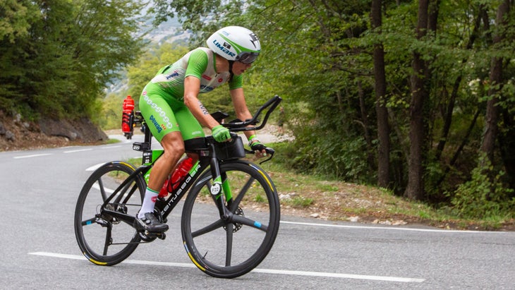 woman riding triathlon bike on road