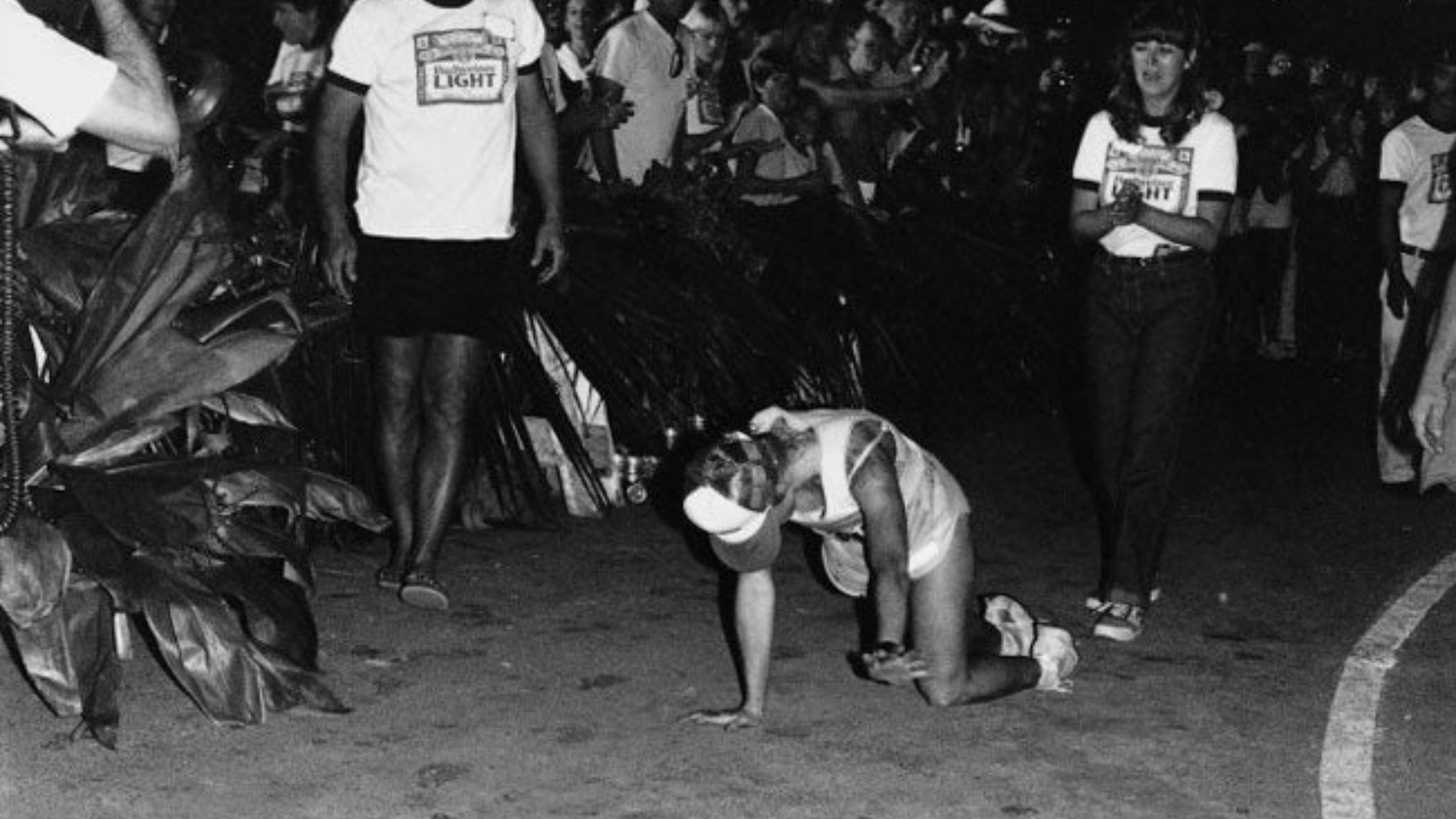 young woman, Julie Moss, crawls on her hands and knees to the finish line of the 1982 Ironman World Championship in this black-and-white photo