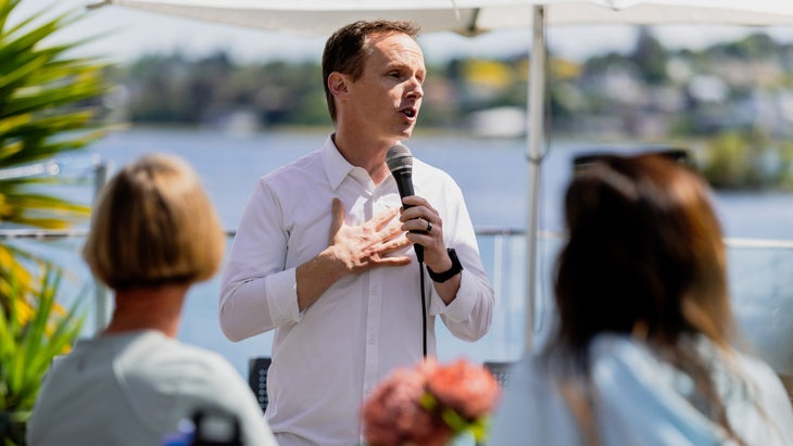 Scott DeRue speaks at a Women for Tri gathering, one of many events the Ironman CEO attended over the past year to meet triathletes and gather insights on how to improve their multisport experience.