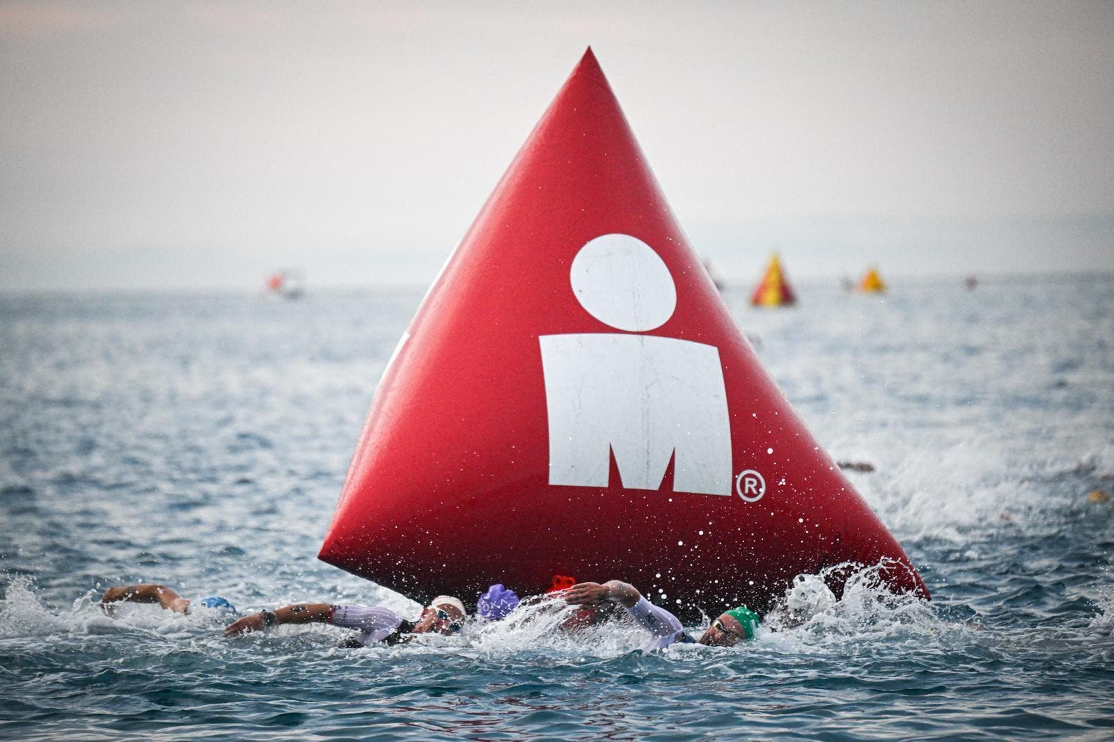 The men's pro field powers through the swim course at the 2025 Ironman world championship in Nice, France.