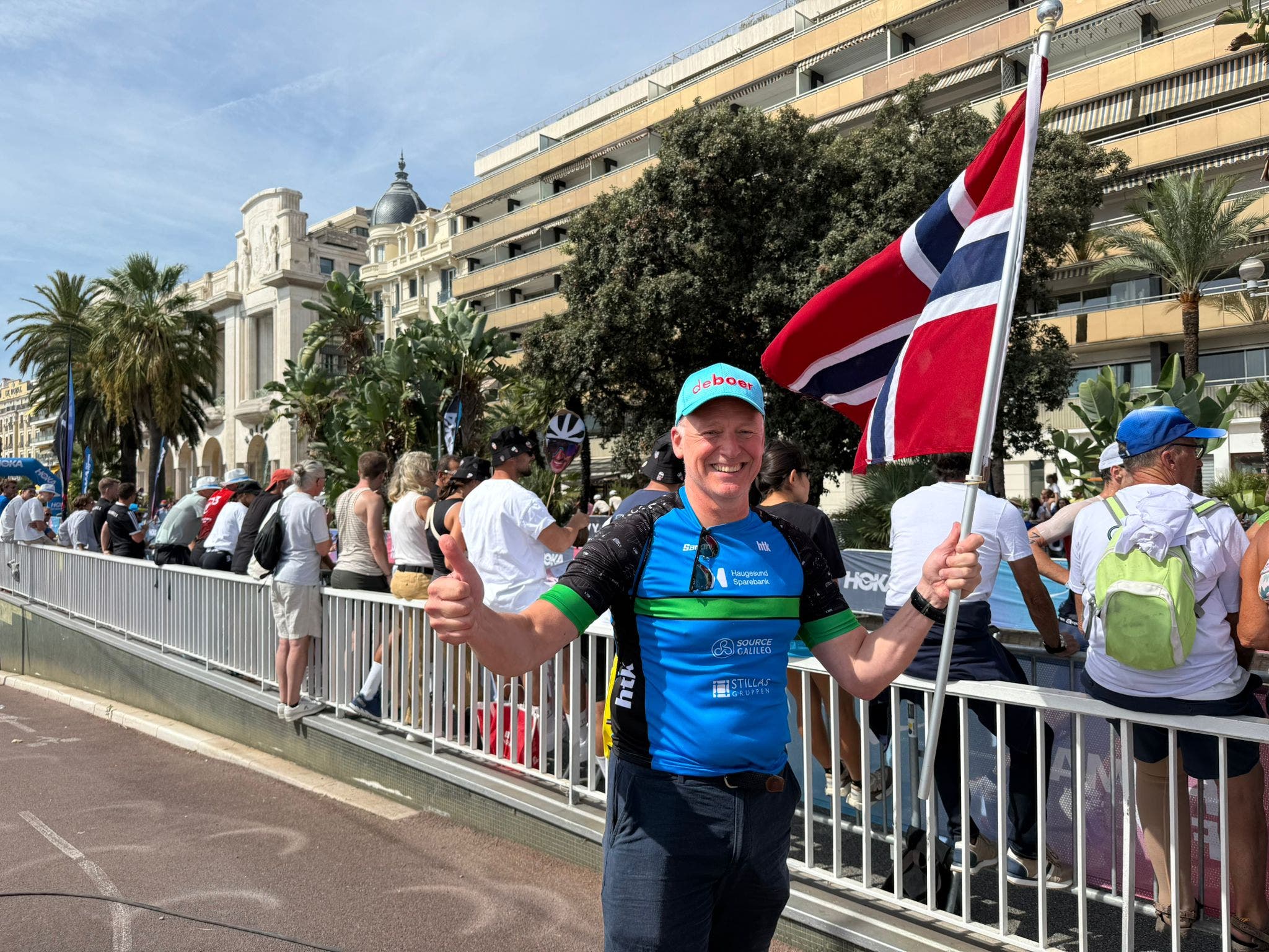 Ivar Jacobsen of Norway holds his country's flag in celebration of the Norwegian performances at the men's 2025 Ironman World Championship.