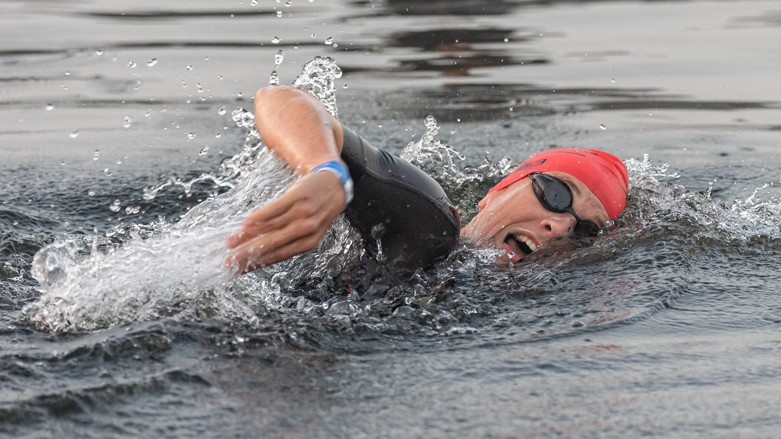 A triathlete breathes during the swimming portion of a triathlon.