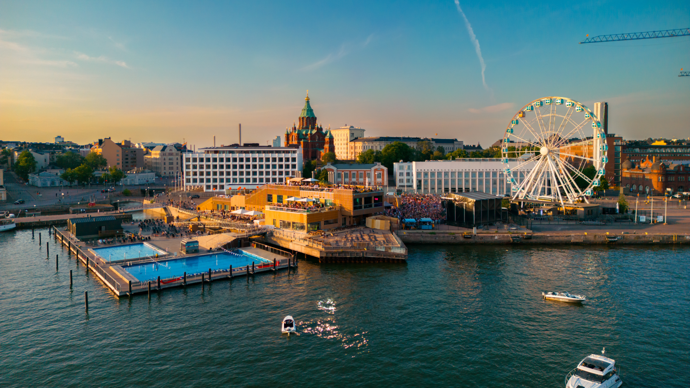 Overhead shot of Helsinki city center with urban buildings, sea and three Alas Baths