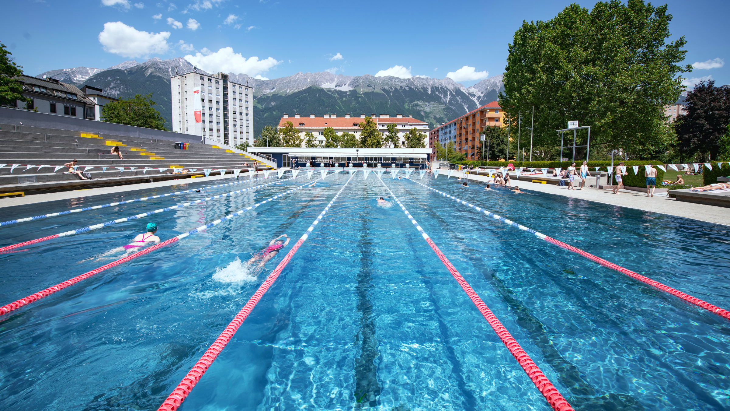 Olympic-sized swimming pool with snow-capped mountains in the background