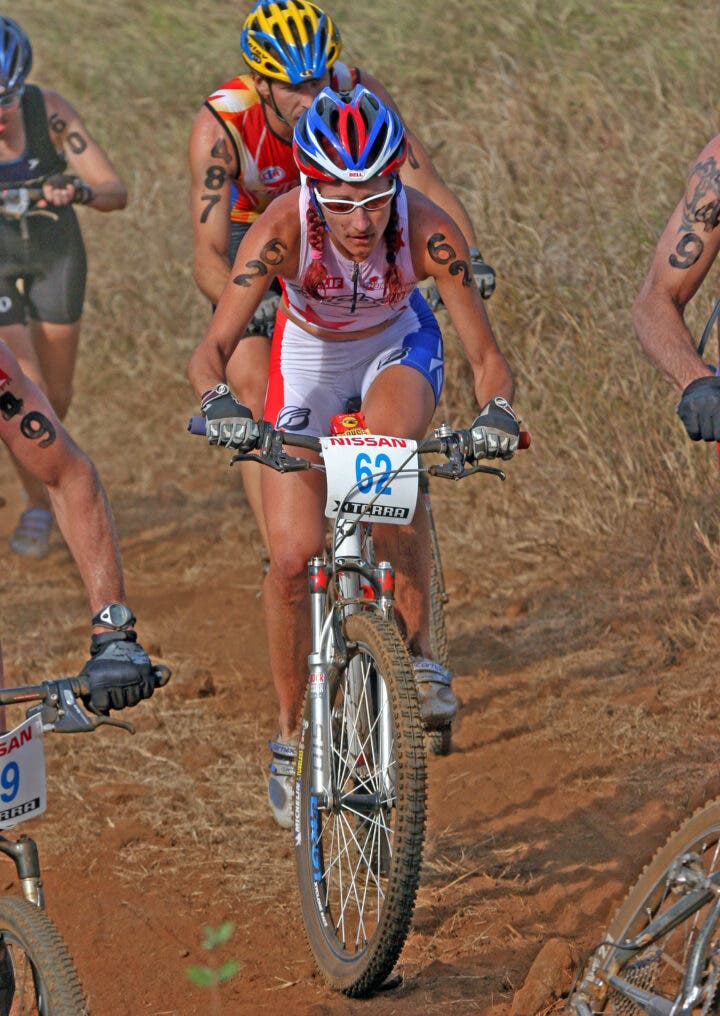 Before her battle with cancer, XTERRA World Champion Jamie Whitmore (USA) was the face of the women’s pro field, often spotted leading a pack of men on climbs, as she is here in 2004.