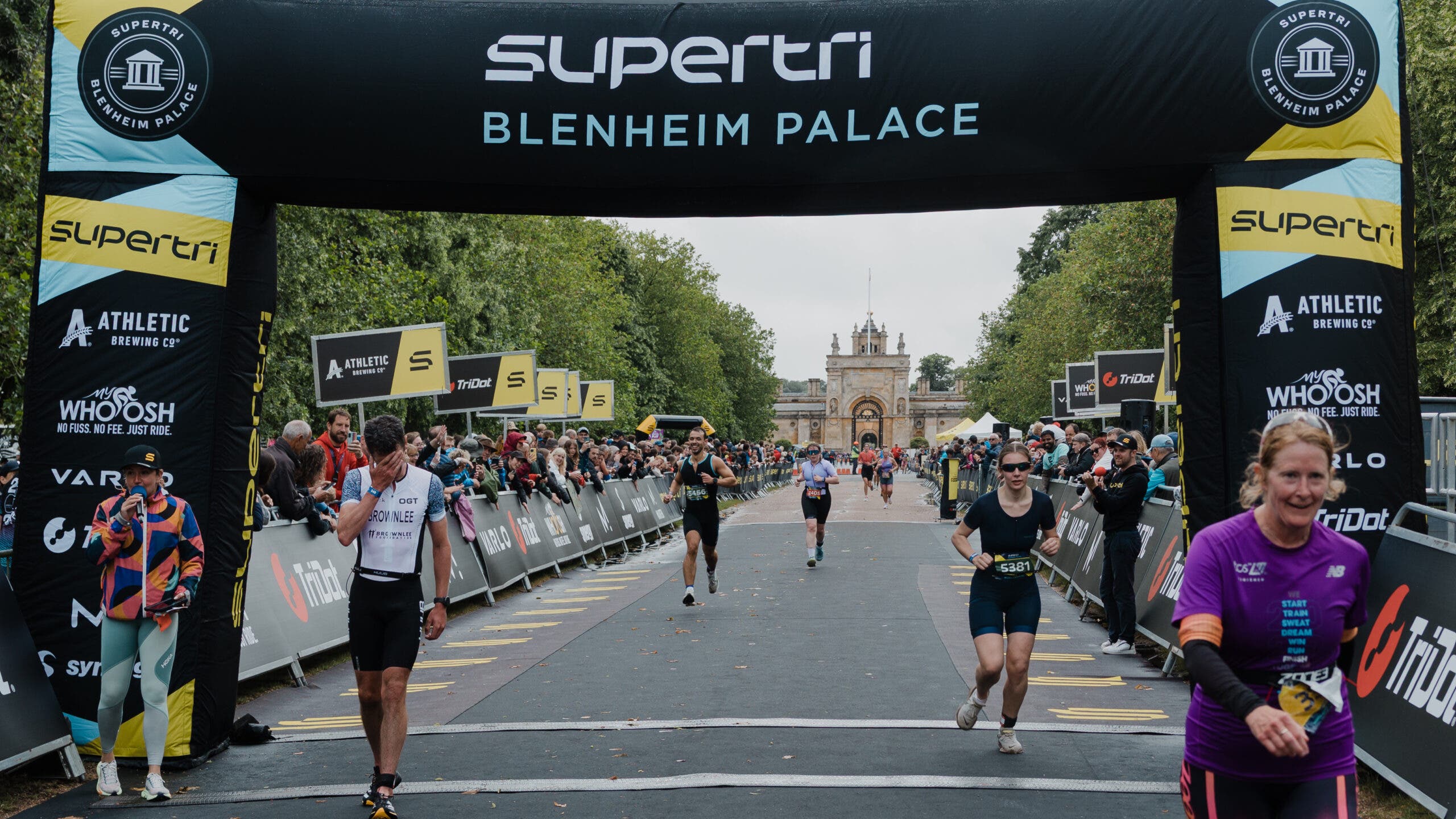 Several sprint triathlons into his weekend attempt at 10 finish lines, Brownlee puts his head in his hand as he finishes another race, one step closer to his goal.