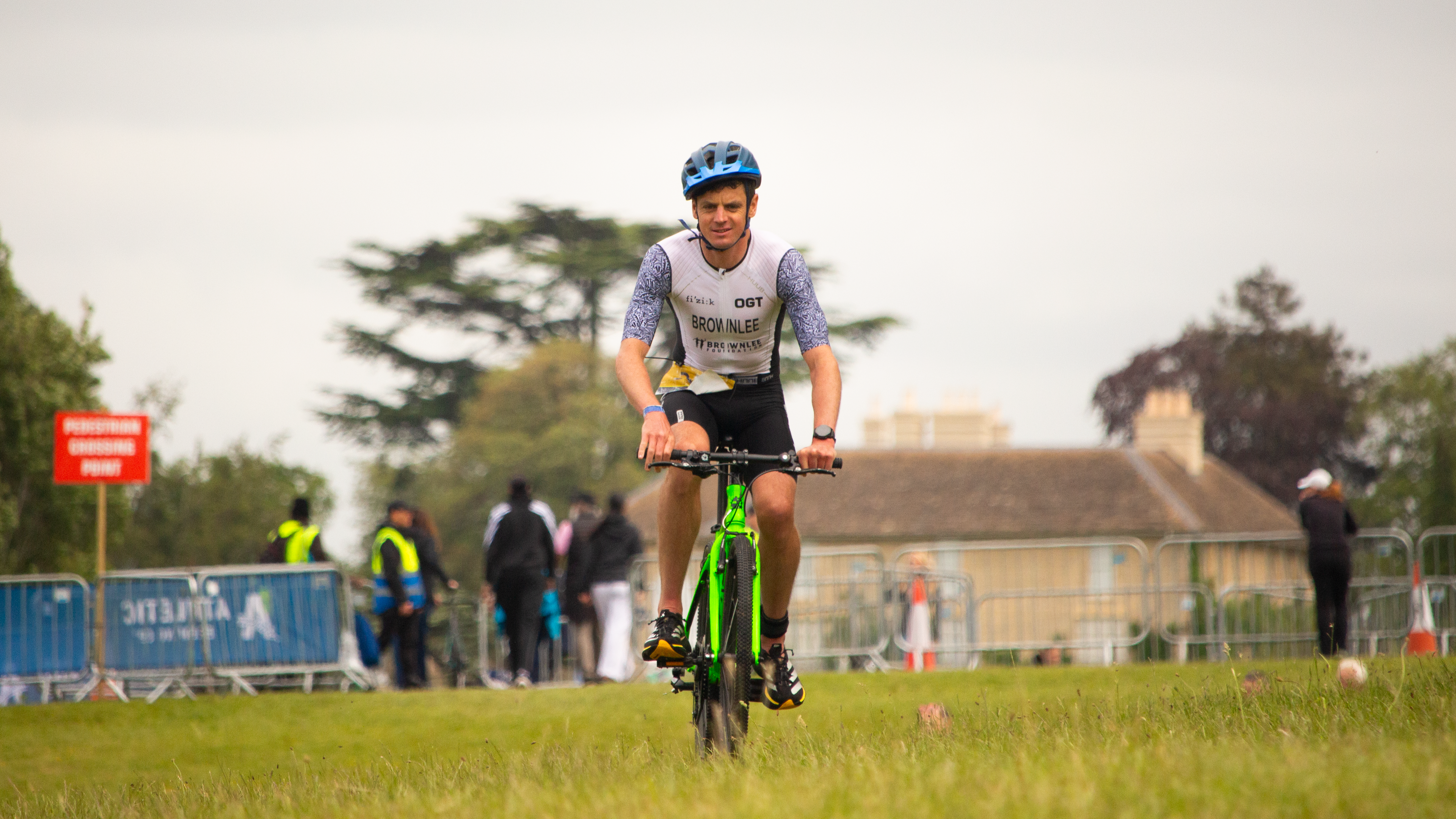 Getting from the finish line back to the swim start meant traversing about 600 meters, so Brownlee borrowed a child's bike to save some energy.