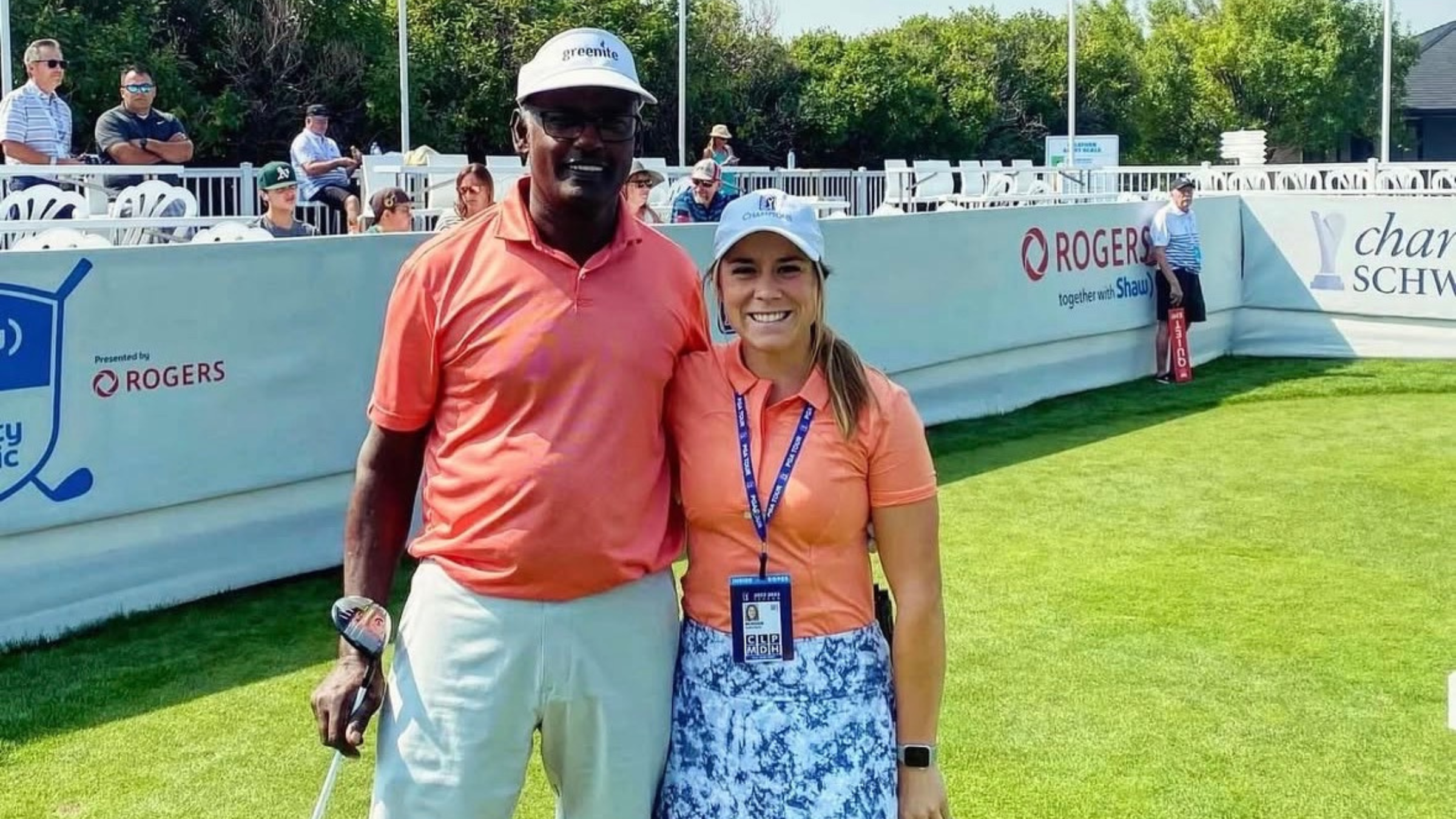 woman and man standing next to each other on golf course in golf attire