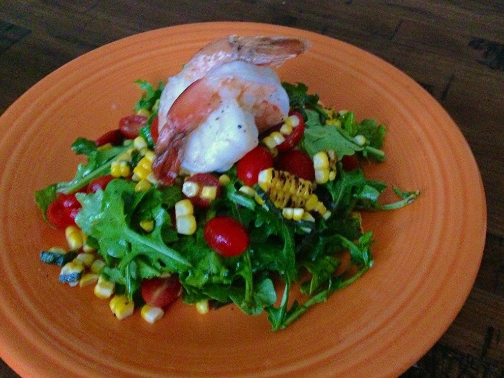 corn, basil, and arugula salad with shrimp on top