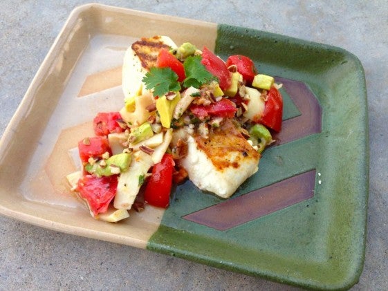 Tomato and avocado salad on top of halibut